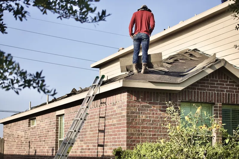Professional roofer working on a residential roof in Lynn Woodoaks